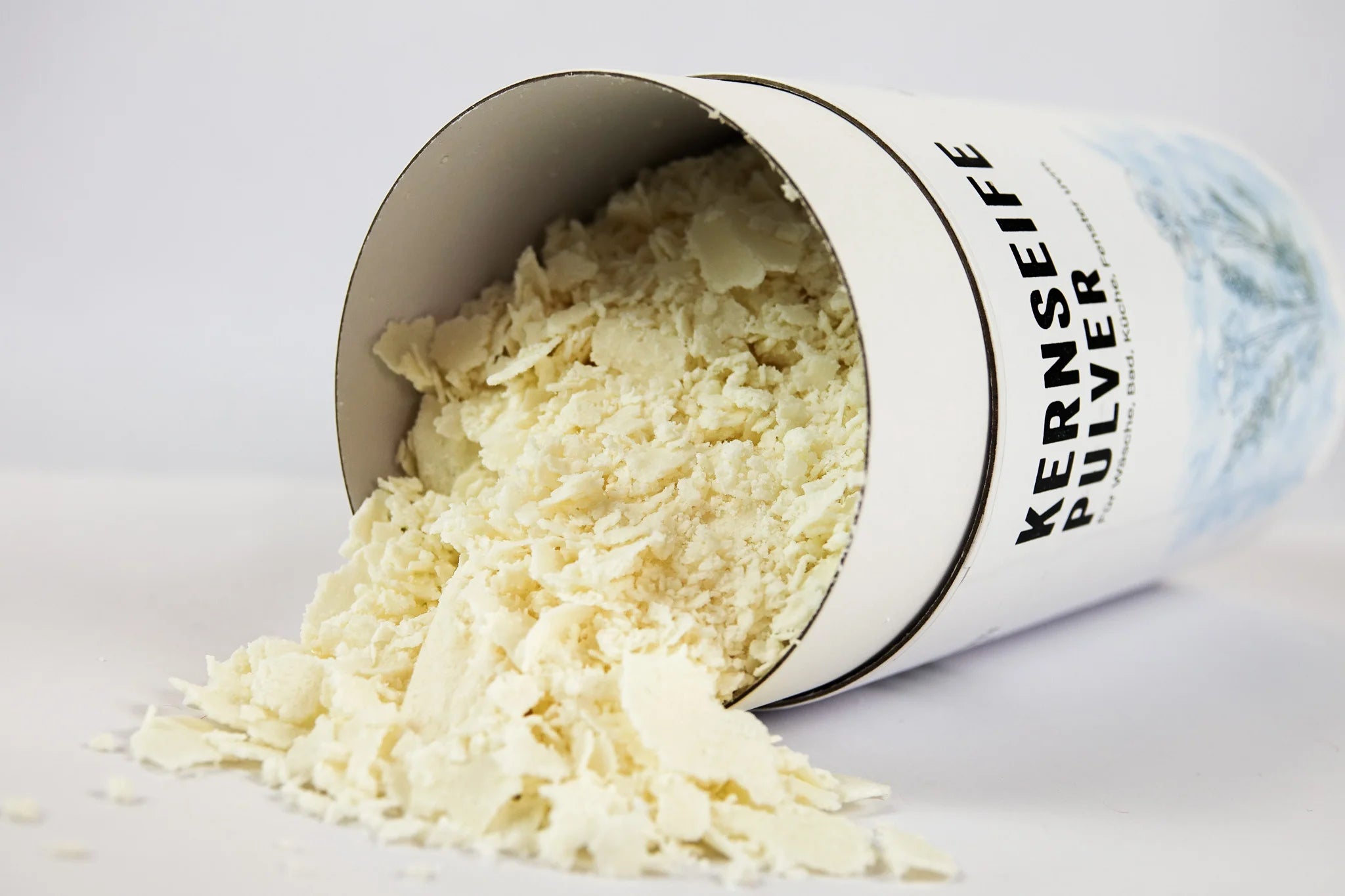 Kernseife Flocken in weißer Pappdose liegend